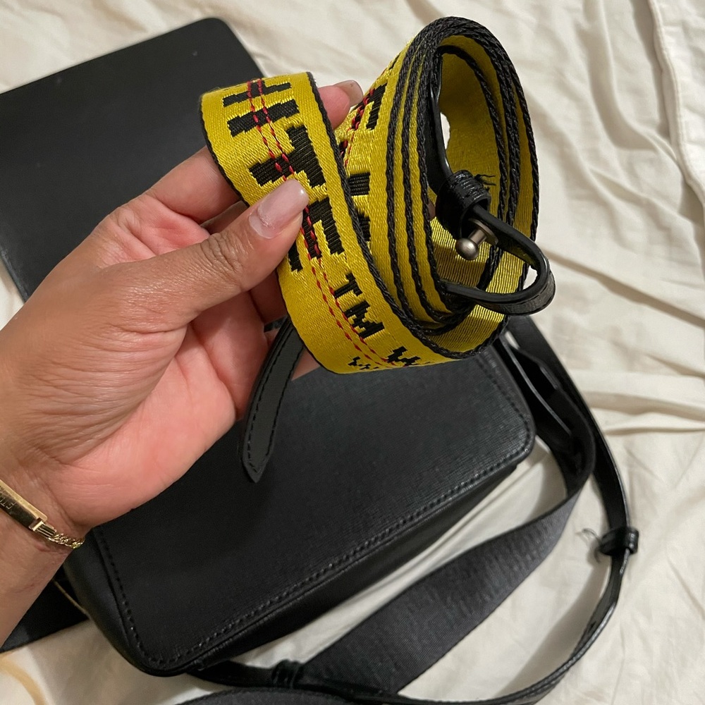 Off white bag with extra yellow strap.